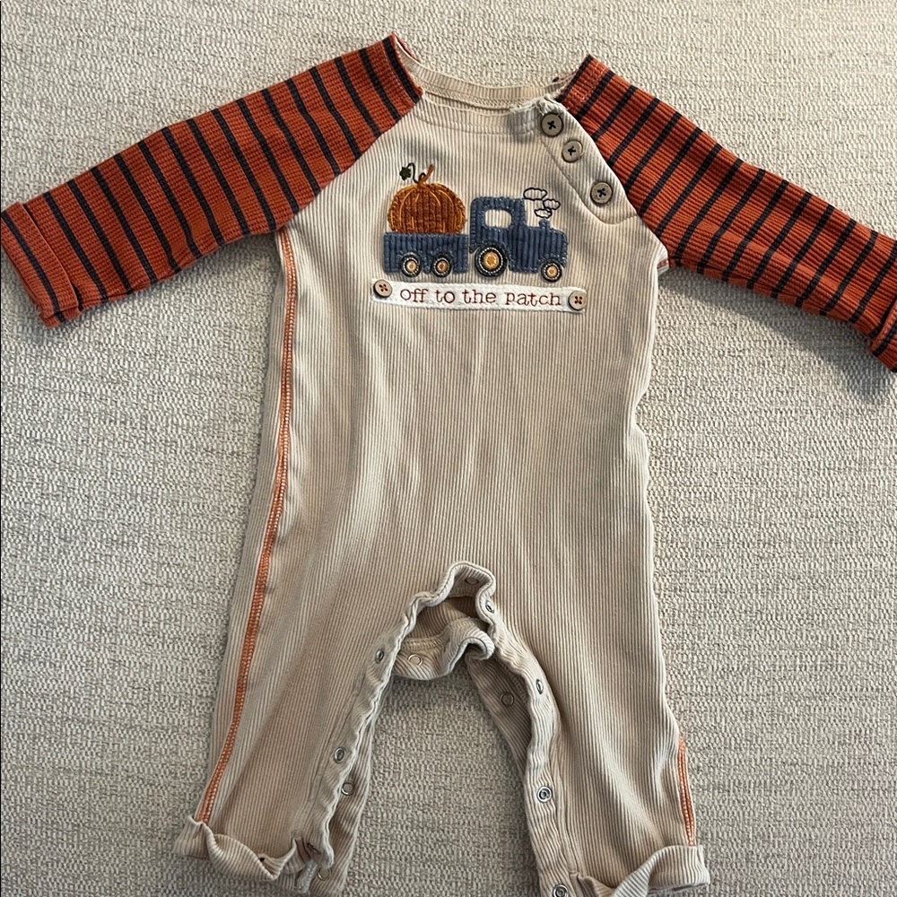 Mud Pie Cream Romper with Orange Striped Sleeves and Blue Truck